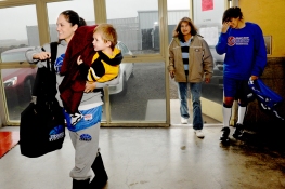 Rebekah Calvert arrives at practice last week with son Maximo in tow as her mother Val, middle, looks on. Calvert says she wouldn’t be able to juggle school and basketball without the support of her family. (Rocklin CA, 2009)